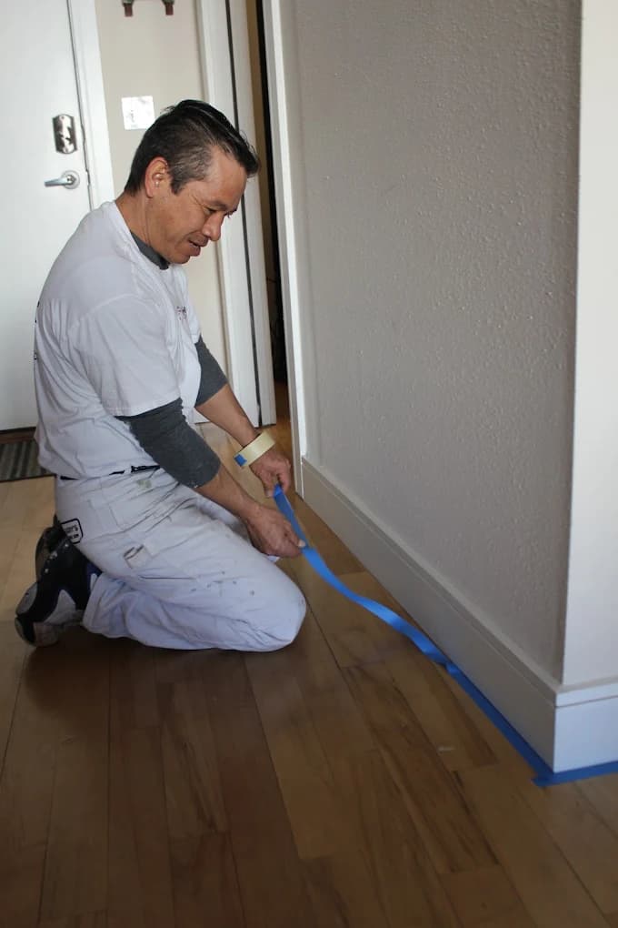Helix painter masking a doorway before cutting in