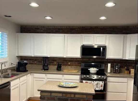 The same kitchen with the cabinets resprayed white
